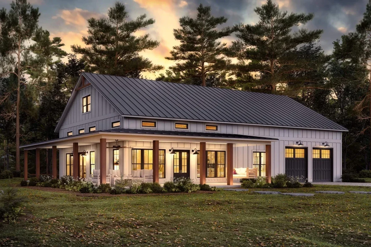 Barndominium design rendering with white board-and-batten siding, a dark standing-seam metal roof, a wraparound porch with wood posts and a two-bay garage at dusk