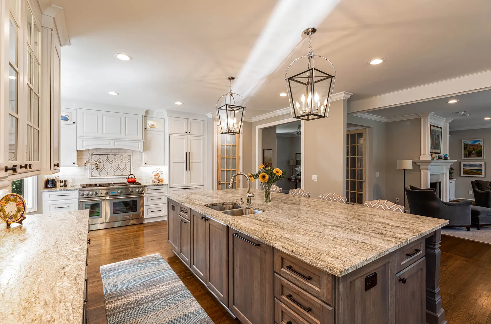 Large kitchen island with a flowing granite top and double sink in a Mariemont, Ohio kitchen