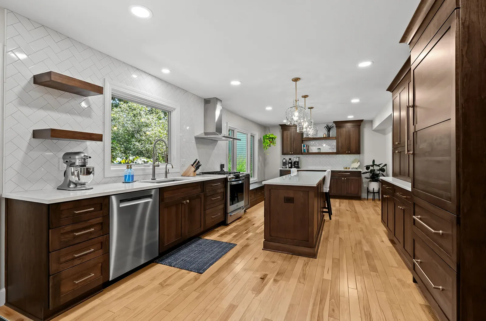 Cherry kitchen with built-in bench, island and herringbone backsplash