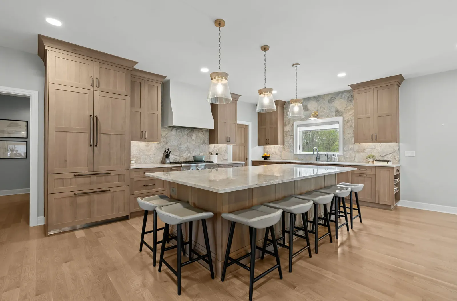 Award-winning organic kitchen with plaster range hood and natural stone backsplash