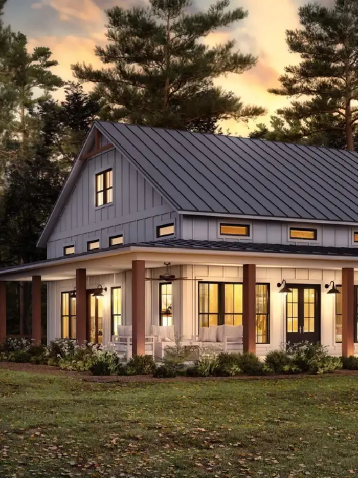 Barn-style home exterior with standing-seam metal roof and sliding barn doors