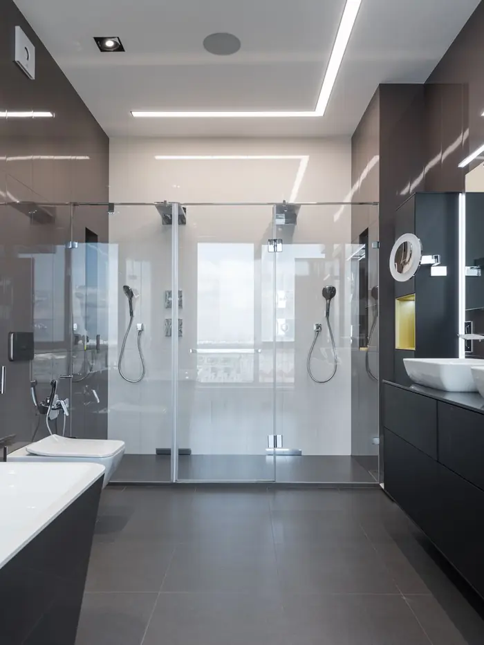 Walk-in shower with frameless glass enclosure and full-height tile